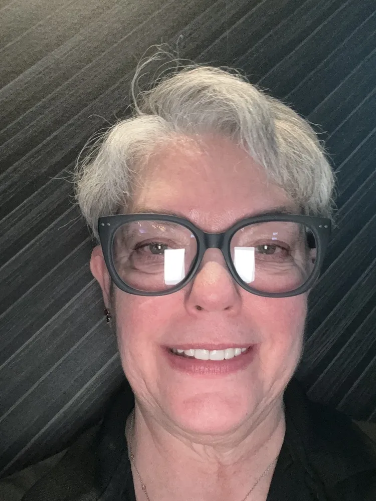 Belinda smiling in LOOK OPTIC Evita frames with dark rims