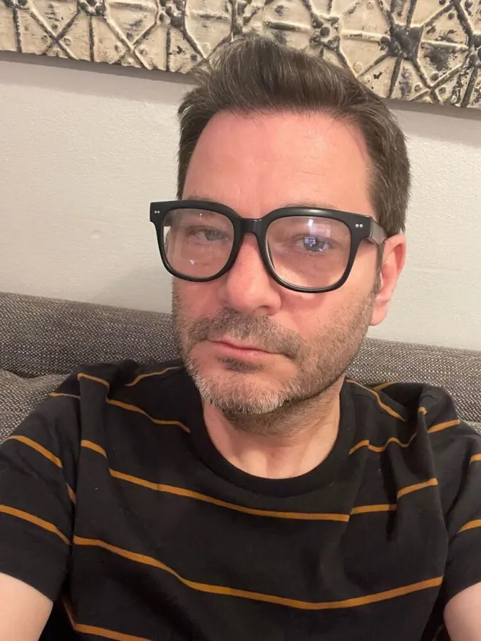 Cameron wearing LOOK OPTIC Laurel readers in black, striped tee