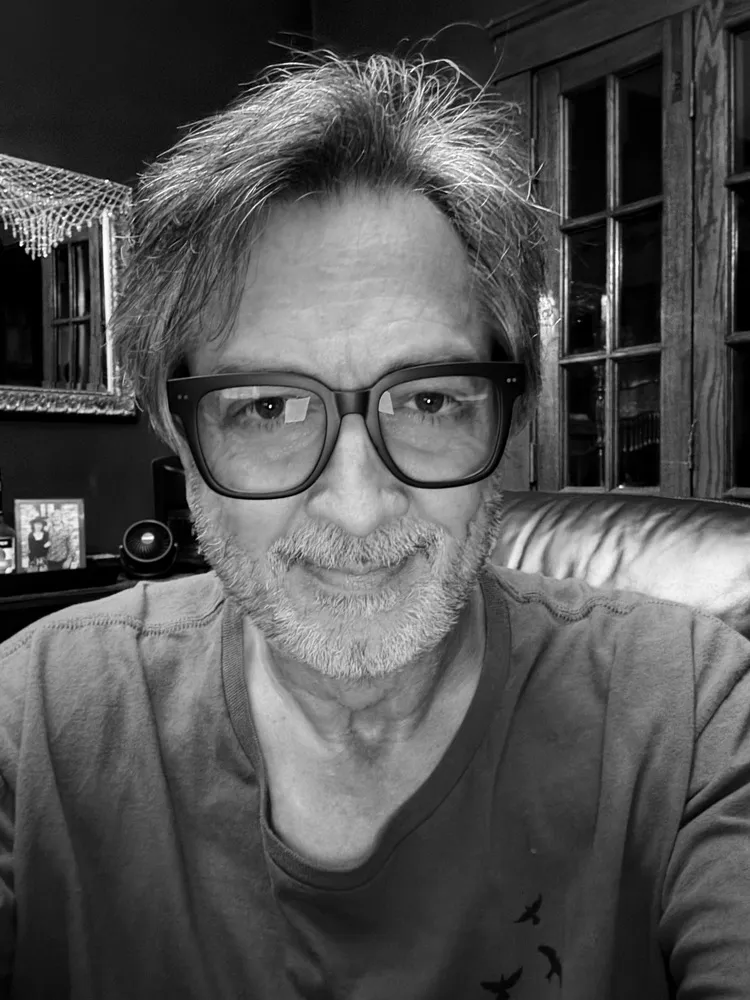 Eric wearing LOOK OPTIC Laurel blue light glasses with dark square frames