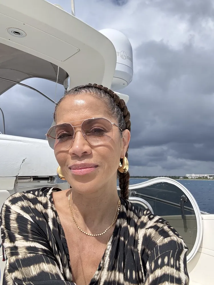Leslee wearing LOOK OPTIC Muse Progressives with gold-rimmed frames, outdoors on an overcast day