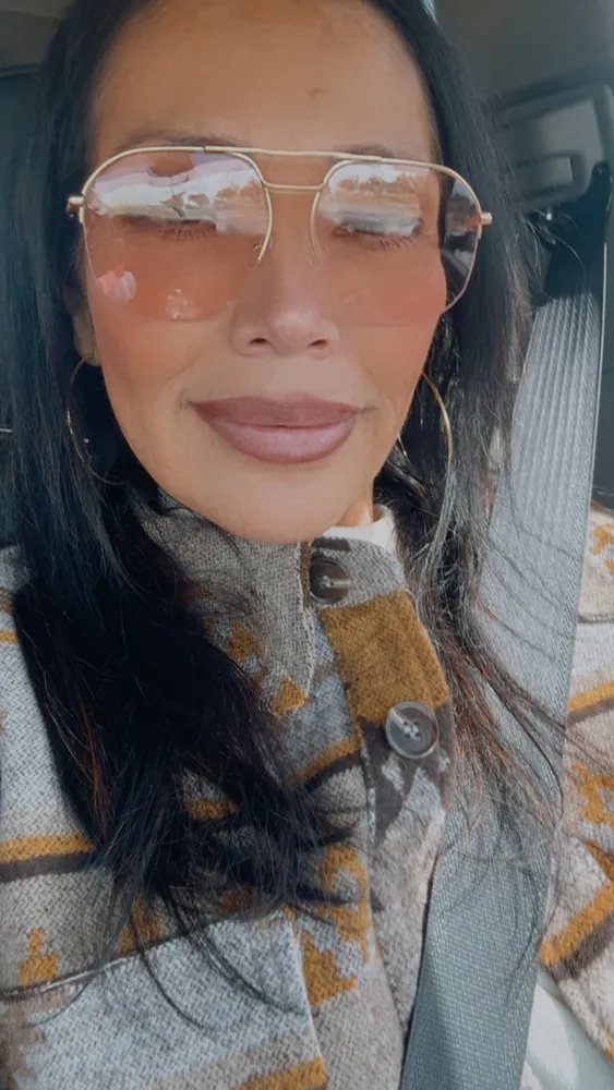 Marisol wearing LOOK OPTIC Muse Progressives with tinted lenses, in a car